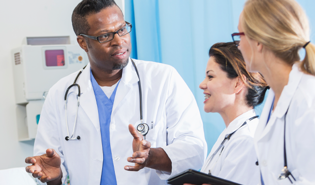 Physicians in white lab coats collaborating