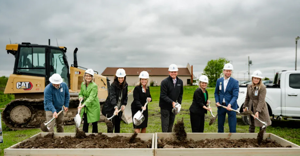People with shovels digging in dirt