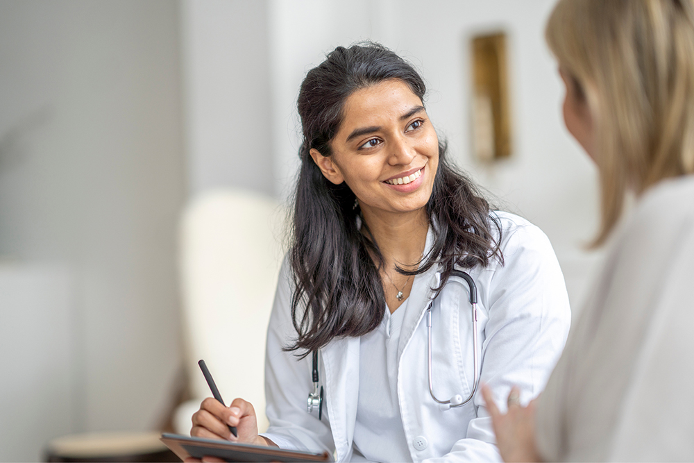 Smiling doctor speaking with patient